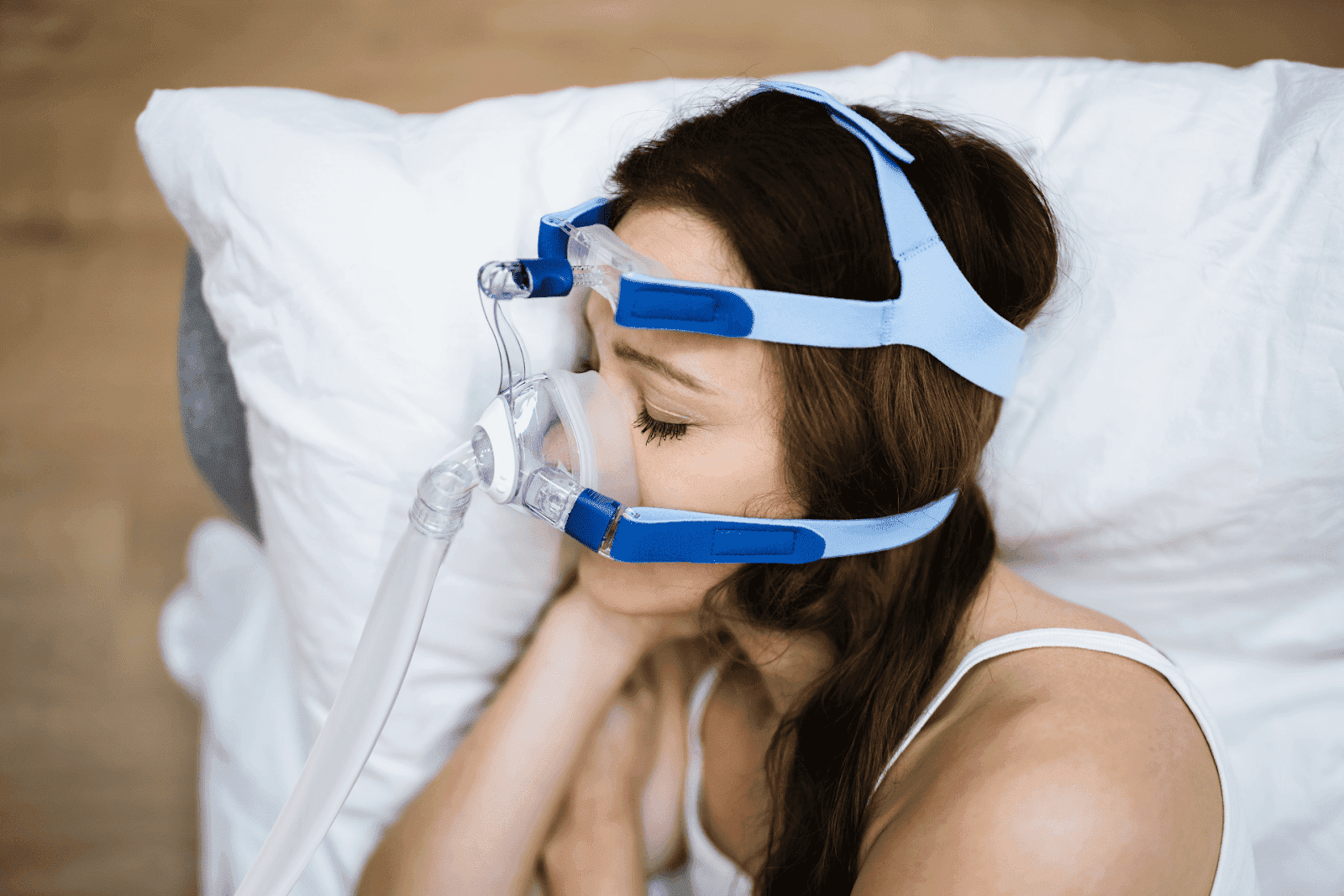 Woman sleeping while wearing a CPAP mask for sleep apnea therapy