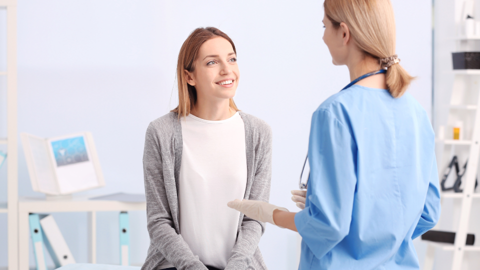 Woman speaking to female doctor.