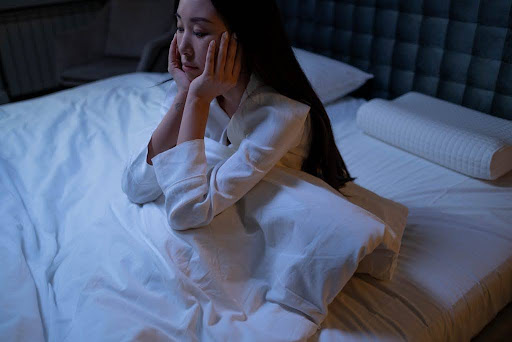 Woman sitting in bed.