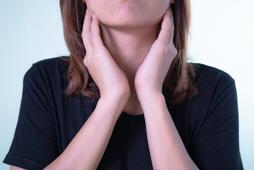 Woman touching her neck