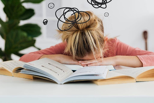 Woman putting her head down on the table.