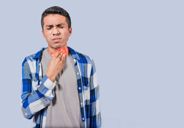 Young Man Experiencing Pain on Throat